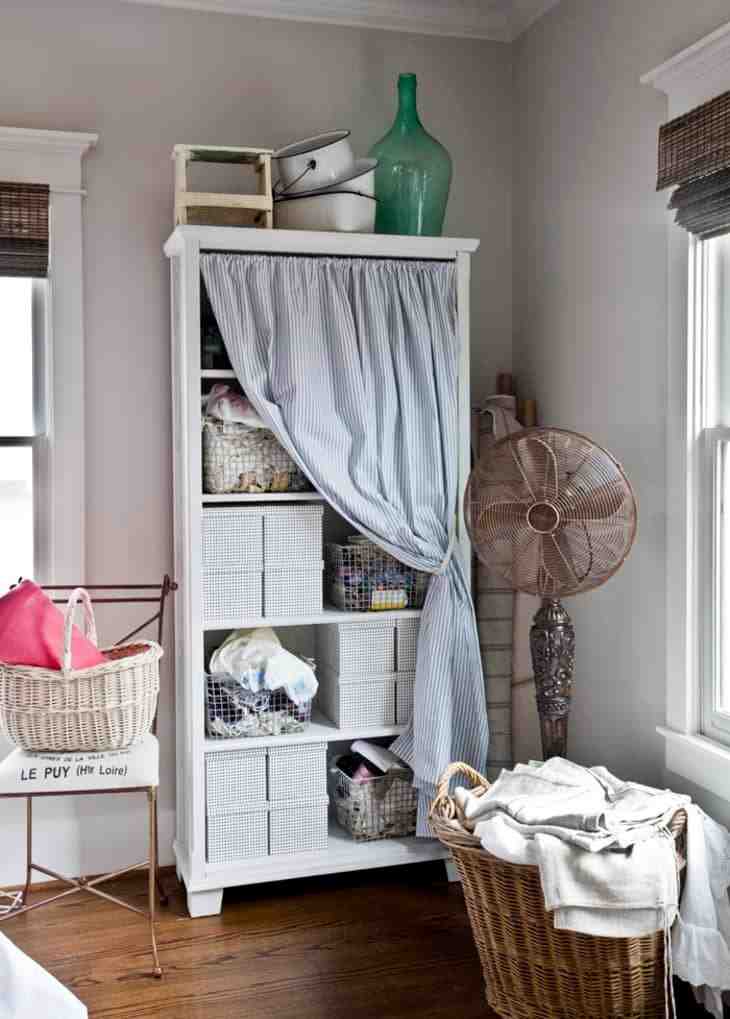 Stripped curtains to cover white wooden cabinet and buckets in it