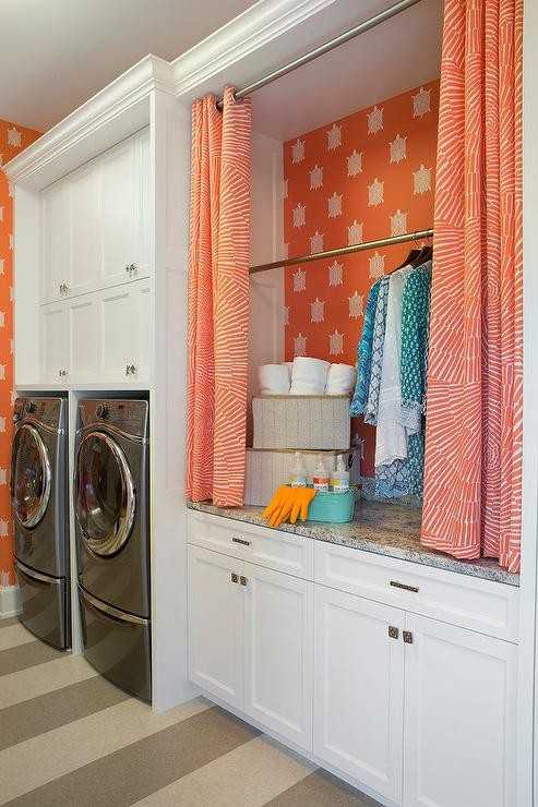 Orange and white curtains used to hide the drying rack in laundry room 