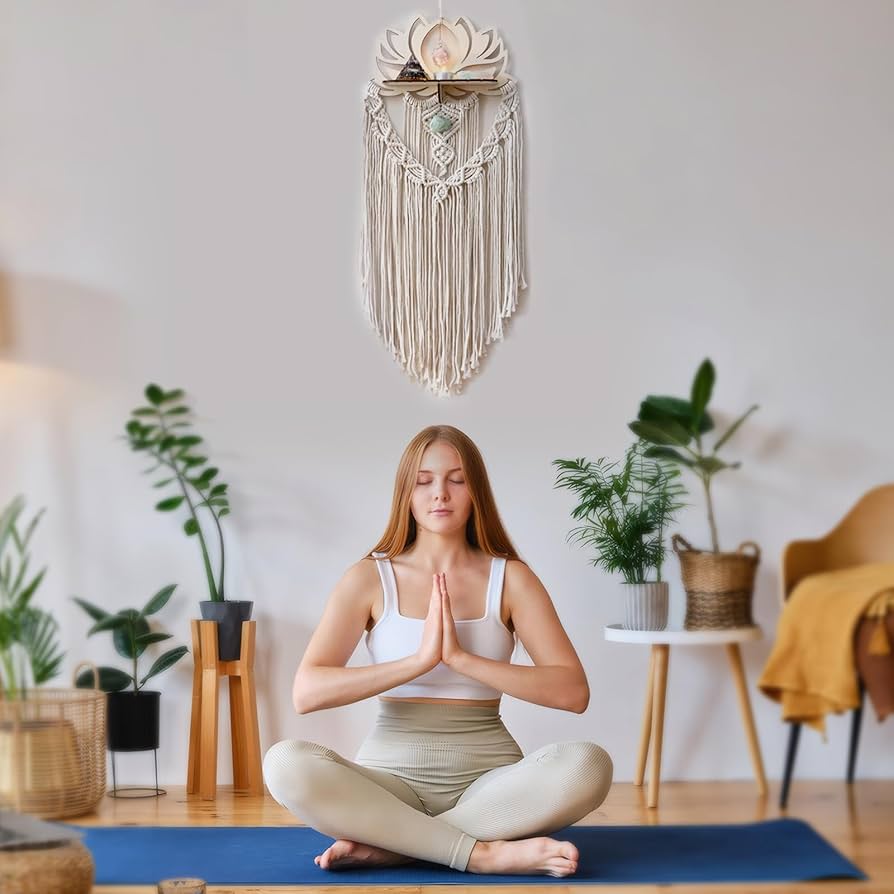 A white macrame hanging on wall behind the girl doing yoga