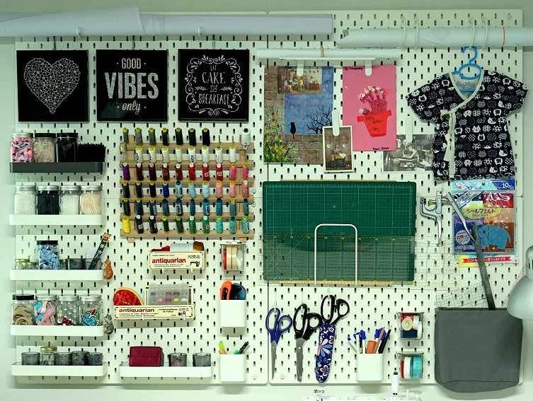 White pegboard with storage i for the sewing room