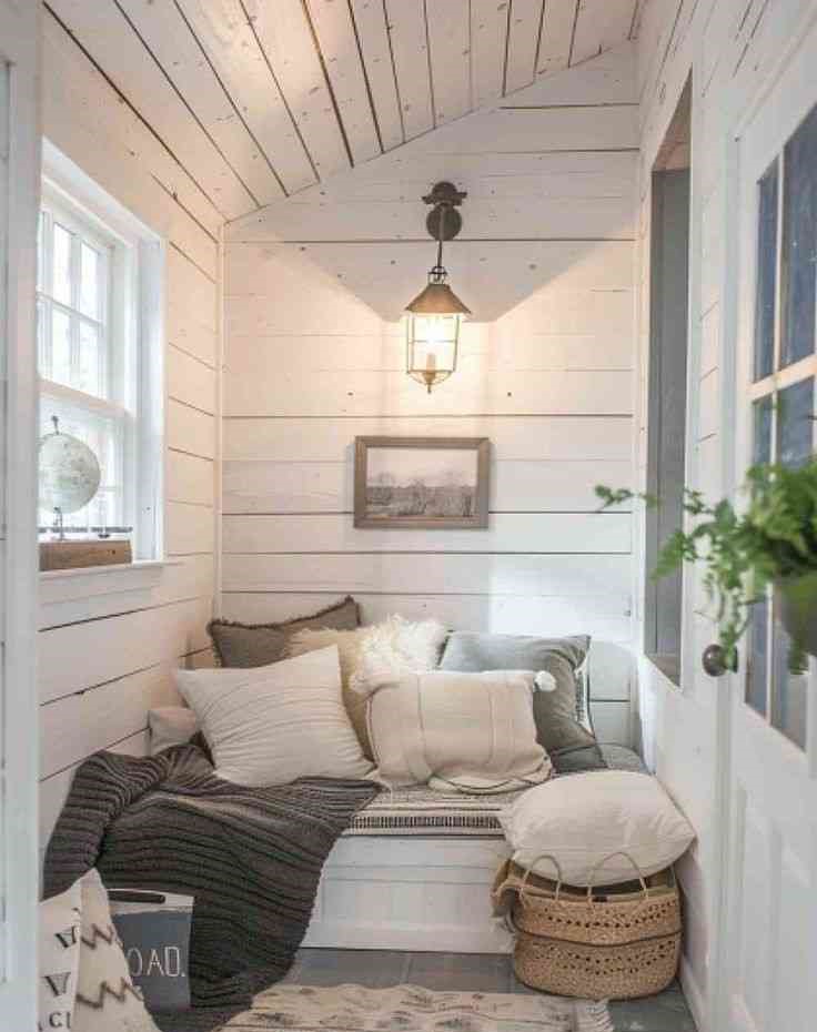 White wooden cabin and a wall mounted seating area 