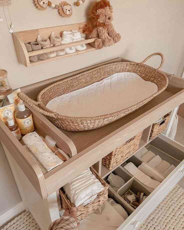 A jute basket placed on a wooden cabinet for the diaper changing station 