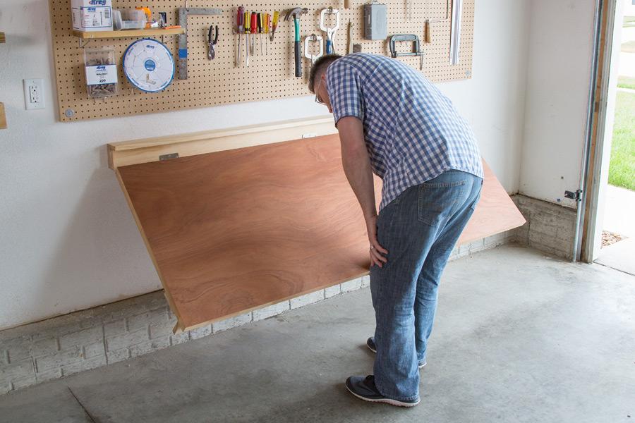 Flooding wooden workbench and a pegboard on wall for the tack room