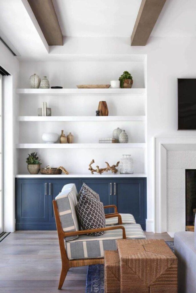 Wooden exposed beams and a blue cabinet and items placed on floating shelves