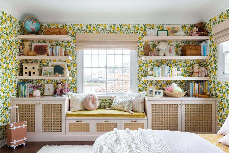 Wooden floating shelves and floral wallpaper on wall and a bench between it