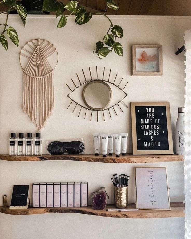 An eye shape mirror and wooden floating shelves under it 