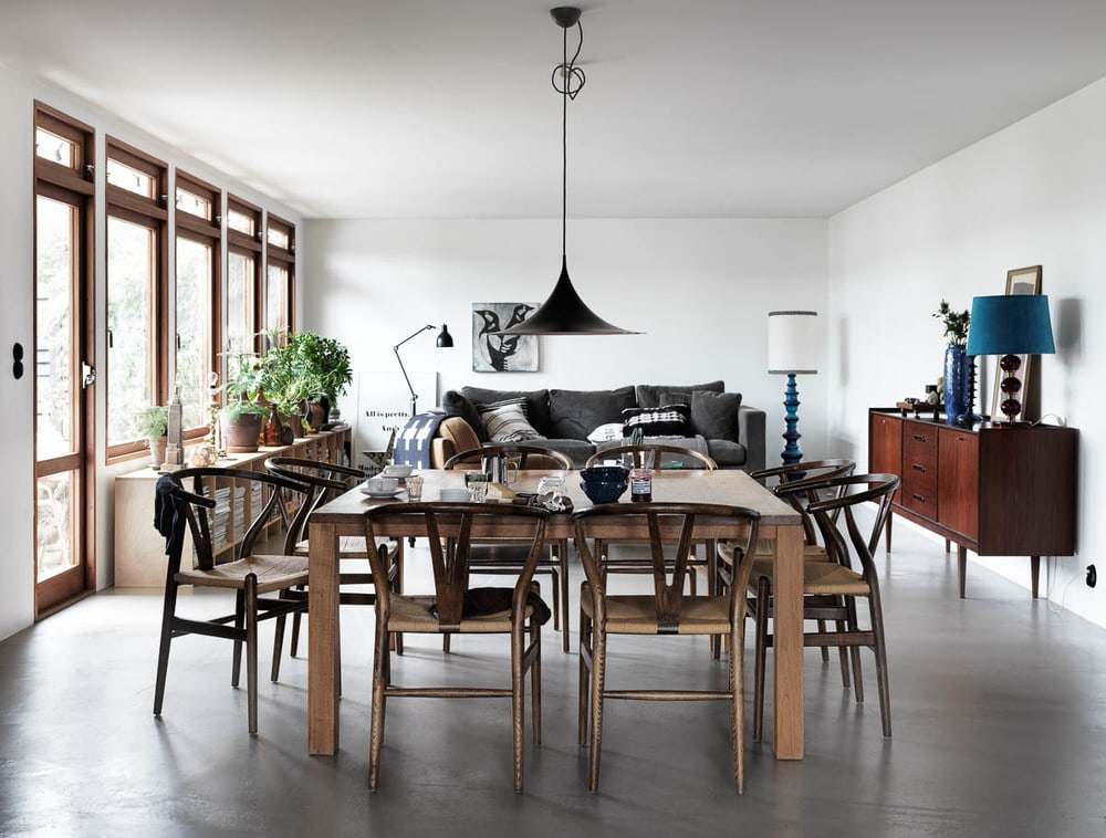Wooden table and chair frame with a white ceiling light and a wooden cabinet