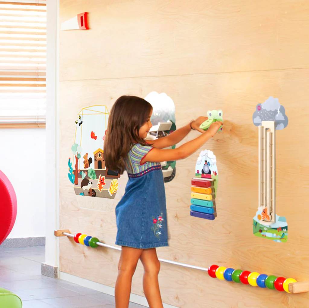Girl playing with games on wooden wall