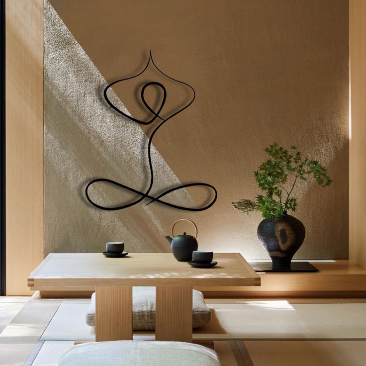 Metal fine line art piece on wall in yoga room