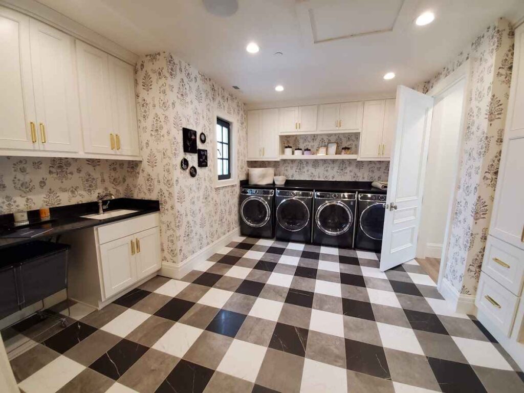 Check design flooring in black and white color with black washing machine and white cabinet's