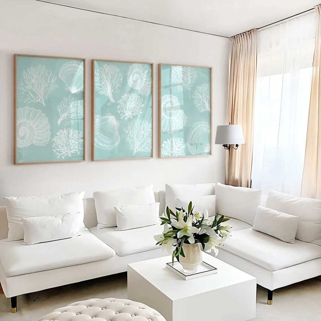 Three wooden frame shell printed art frame on wall and sofa under it with a coffee table