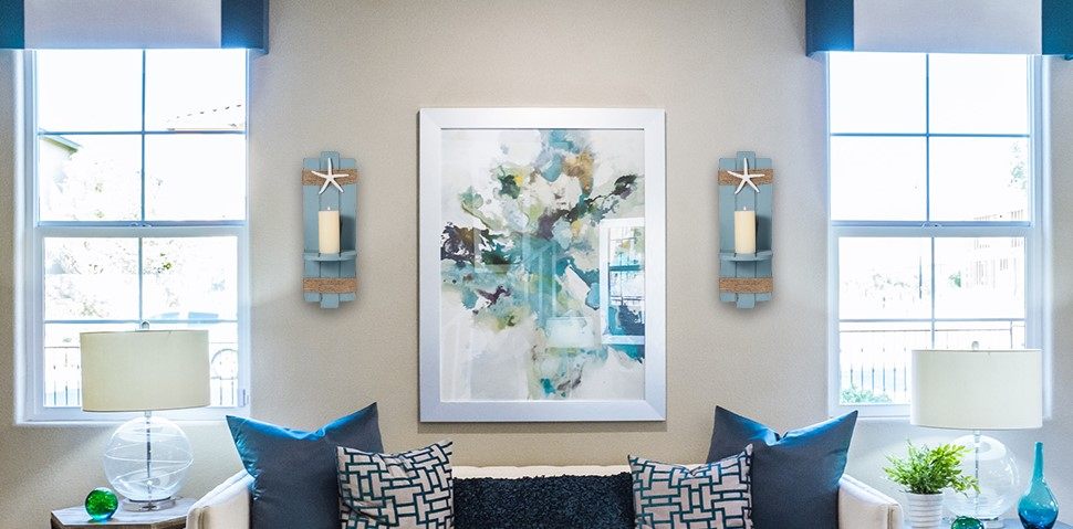two window and two wall scones with star sign and a painting between it 