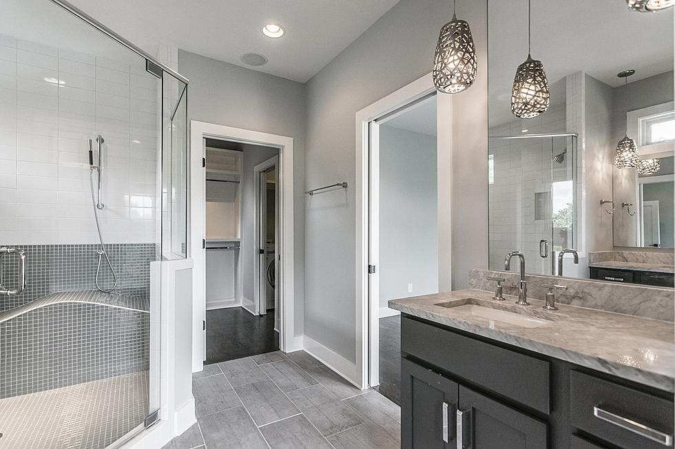 Lights on ceiling above vanity and glass door for the bathing area 