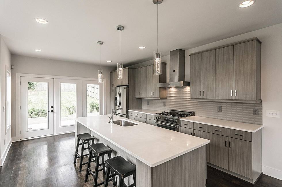 White walls with glass door and ceiling lights and wooden cabinet