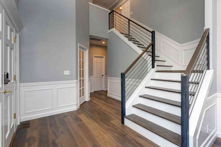 What to Consider Before Updating Major Home Systems a-staircase-with-light-colored-wooden-treads-and-sleek-railing-of-metal-rod