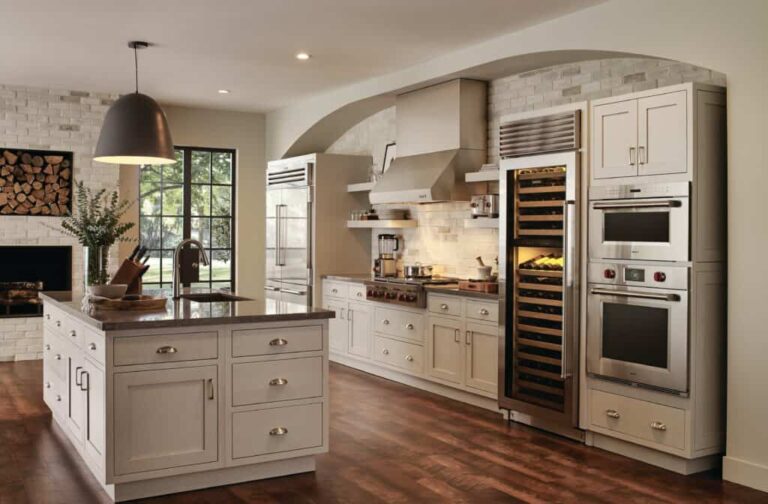 classic-U-shaped-enclosed-kitchen-and-space-features-white-panel-cabinets-with-cup-handle-and-integrated-stainless-steel-appliances