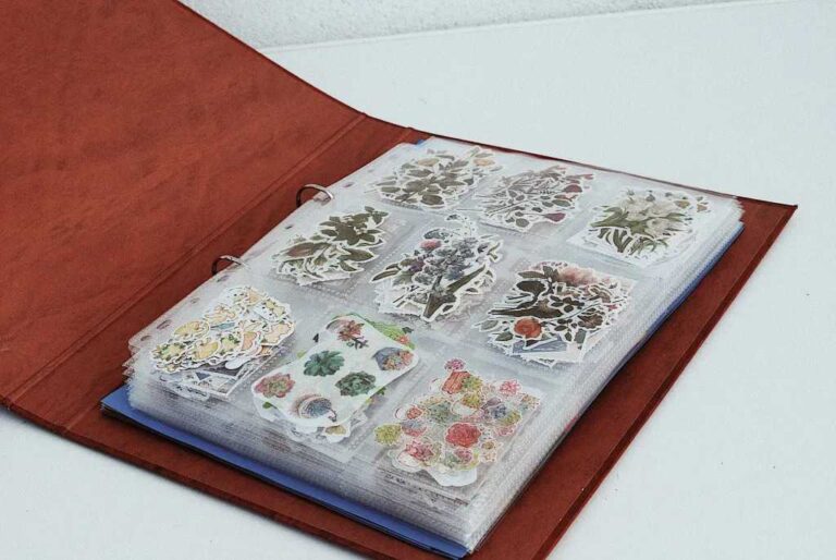 red-covered-notebook-containing-sheets-of-stickers-with-floral-designs