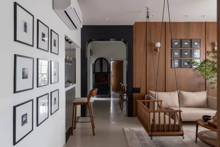 Creating a Comfortable and Stylish Home in the Modern Age the-living-area-includes-a-sofa-white-cushions-and-unique-light-wood-indoor-swing-with-a-cushion