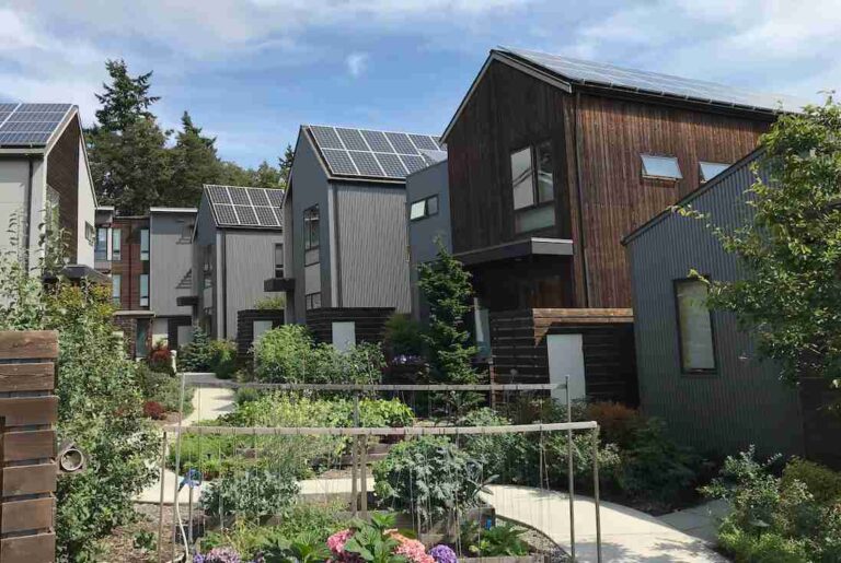 row-of-modern-sustainable-townhouses-that-are-part-of-community-and-several-roofs-are-equipped-with-solar-panels