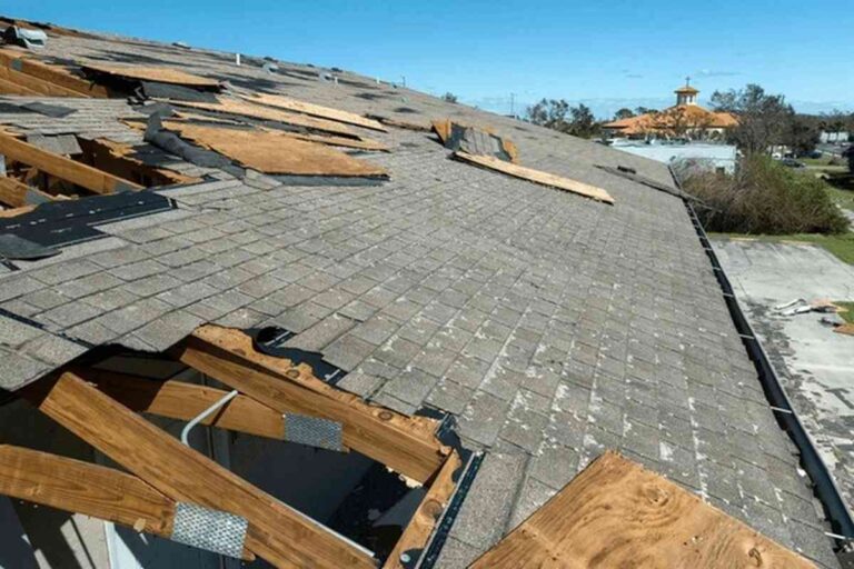 a-large-portion-of-the-roofs-plywood-underlayment-and-support-framing-is-visible-and-exposed-to-the-open-air