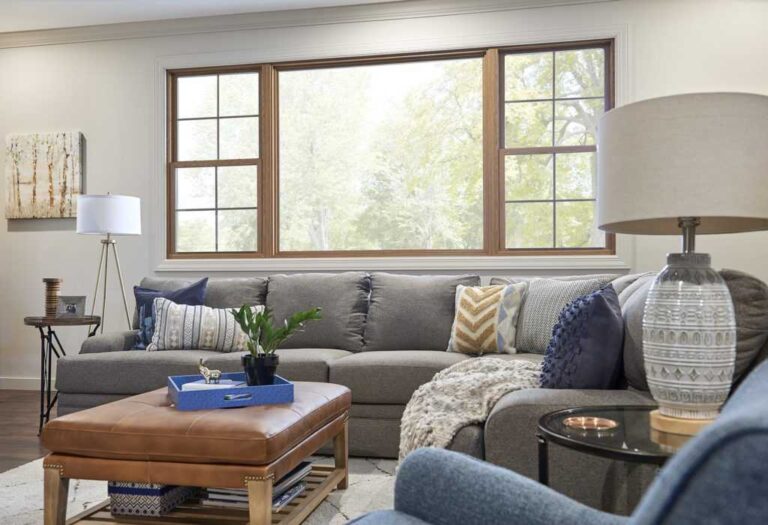 modern-brightly-lit-living-room-interior-features-large-L-shaped-sectional-sofa-in-a-light-blue-or-gray-fabric