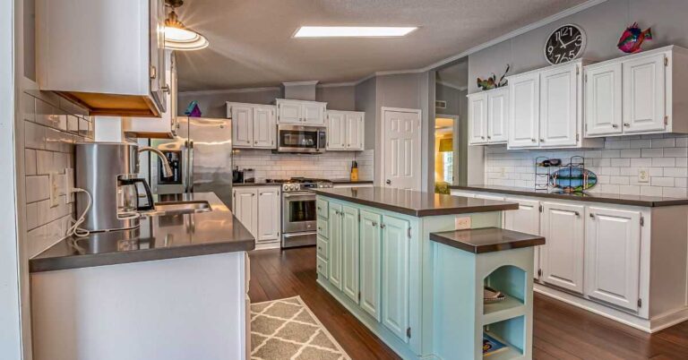 the-room-features-a-spacious-contemporary-layout-centered-around-a-large-kitchen-and-white-cabinetry