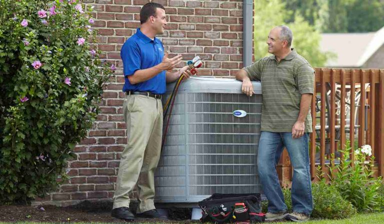 a-professional-technicians-talking-to-a-homeowner-next-to-a-central-air-conditioning-unit